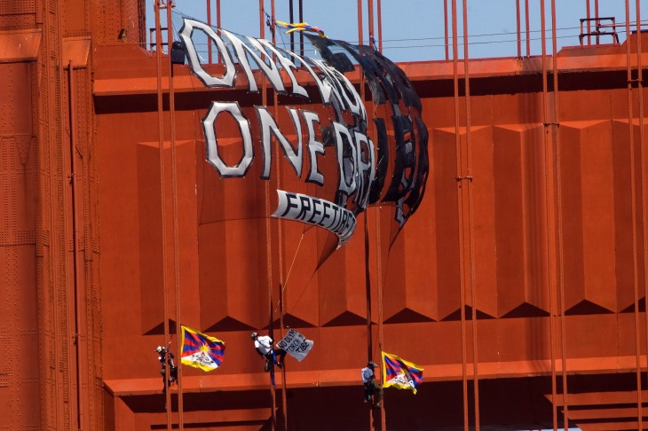 Three protesters climb the Golden Gate Bridge cables and unfurl a banner reading, "One World One Dream, Free Tibet", in protest of the Olympic Torch coming to San Francisco, CA on April 7, 2008. Photo: Jim Herd/SFCitizen