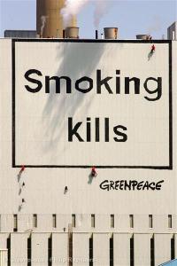 Greenpeace activists hang a large warning box on the outside of the coal-fired power plant of electricity supplier E.ON at the Maasvlakte in June of 2006. Photo: Philip Reynaers.