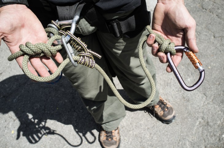 Adjustable lanyard. Notice the four components: barrel knot restricts carabiner movement, prusik for adjustment, screw link tends prusik, eight follow-thru tied directly to central point on harness.