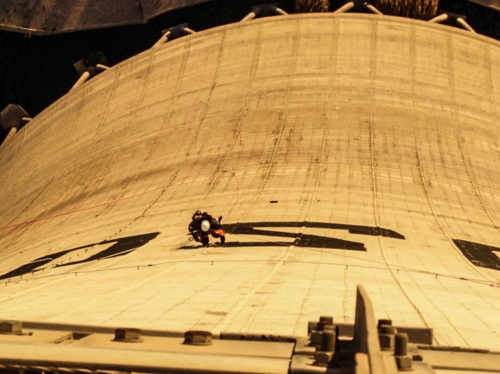 Greenpeace paint "Go Solar" onto the cooling tower of the lignite fueled Agios Dimitrios Power Station in Kozani, Greece on December 9, 2015. Photo: Takis Grigoriou