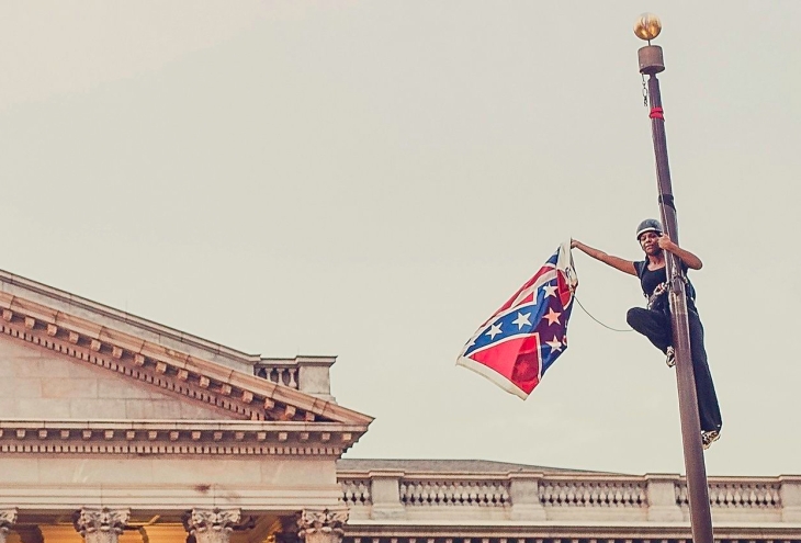 Bree Newsome takes down the confederate flag. Photo: Adam Anderson/Reuters Media Express